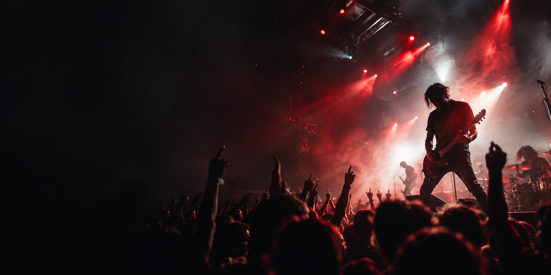 Cinematic live music stage with red light, haze, performer silhouette, and crowd energy